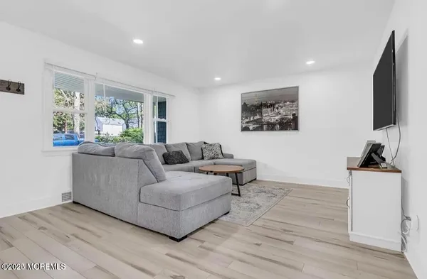 a living room with furniture a large window and a flat screen tv