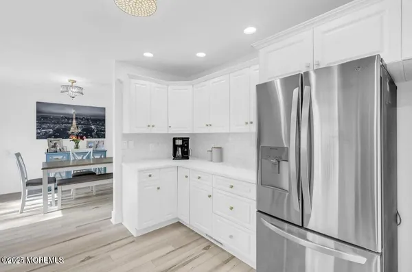 a kitchen with stainless steel appliances a refrigerator sink and cabinets