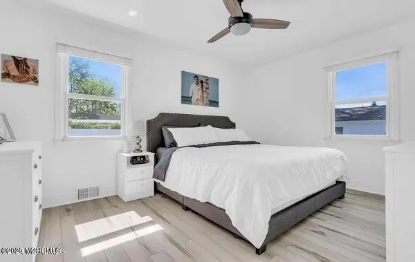 a bedroom with a bed and painting on the wall