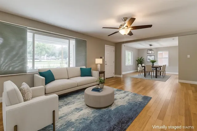 a living room with furniture and a wooden floor