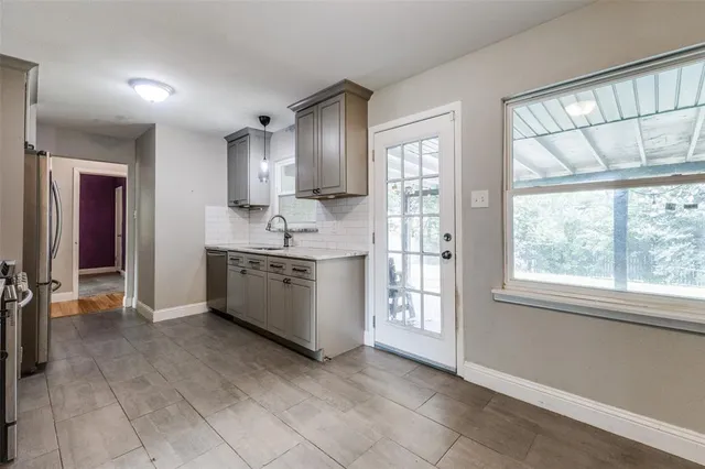 a large white kitchen with a large window