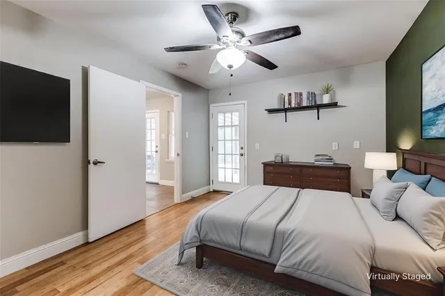 a bedroom with a large bed and a flat screen tv