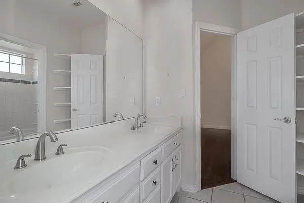a bathroom with 2 sink and a mirror