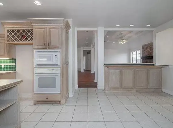 a view of kitchen with cabinets and refrigerator