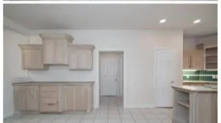 a kitchen with white cabinets and a sink