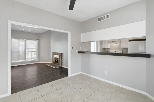 a view of a livingroom with wooden floor and a ceiling fan