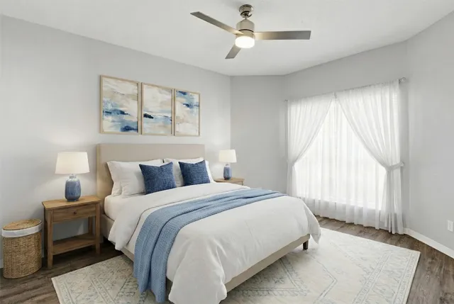 a bedroom with a large bed and a window