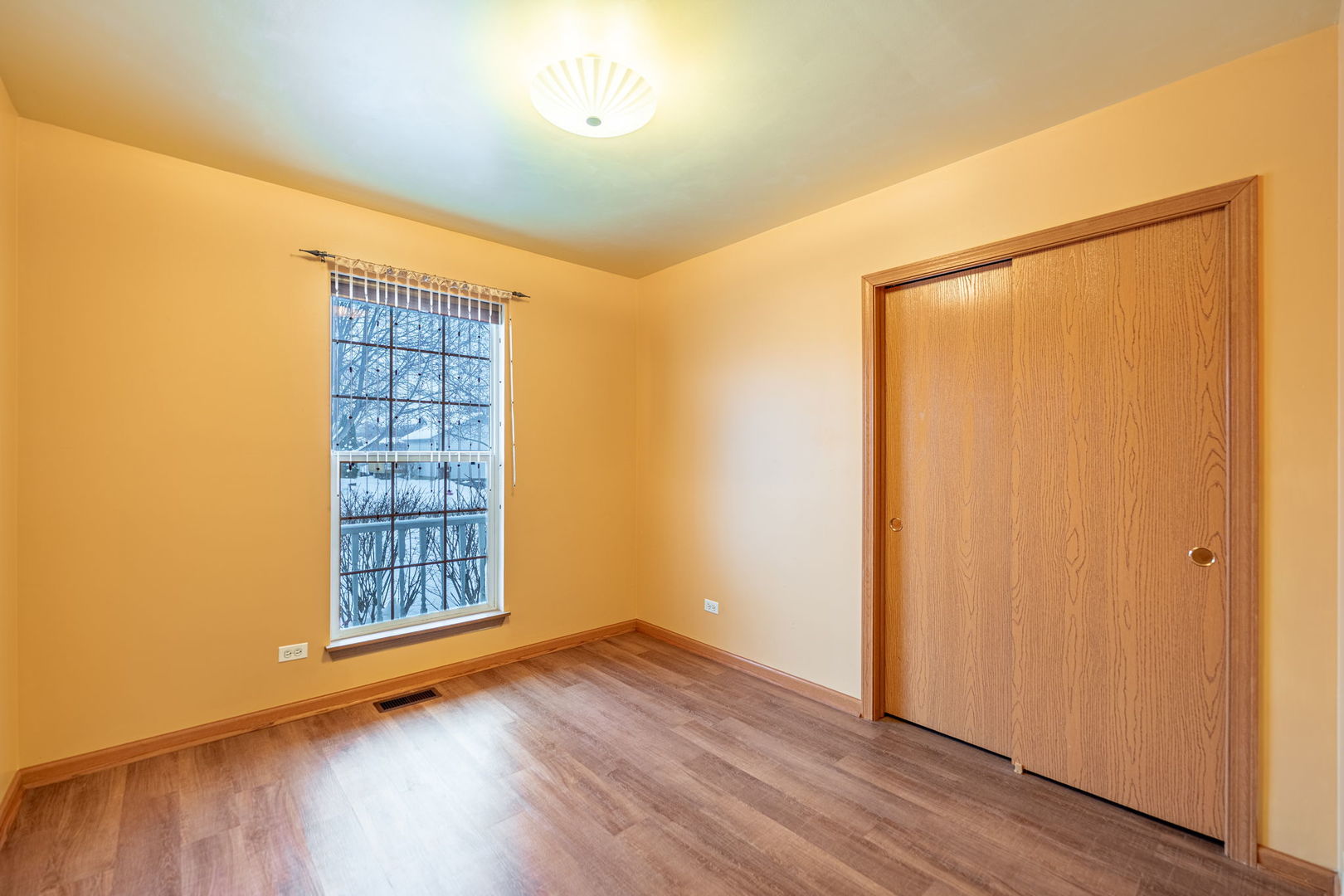 109 Shawnee Lane Harvard, IL 60033 - Photo 14 of 34 an empty room with wooden floor and windows