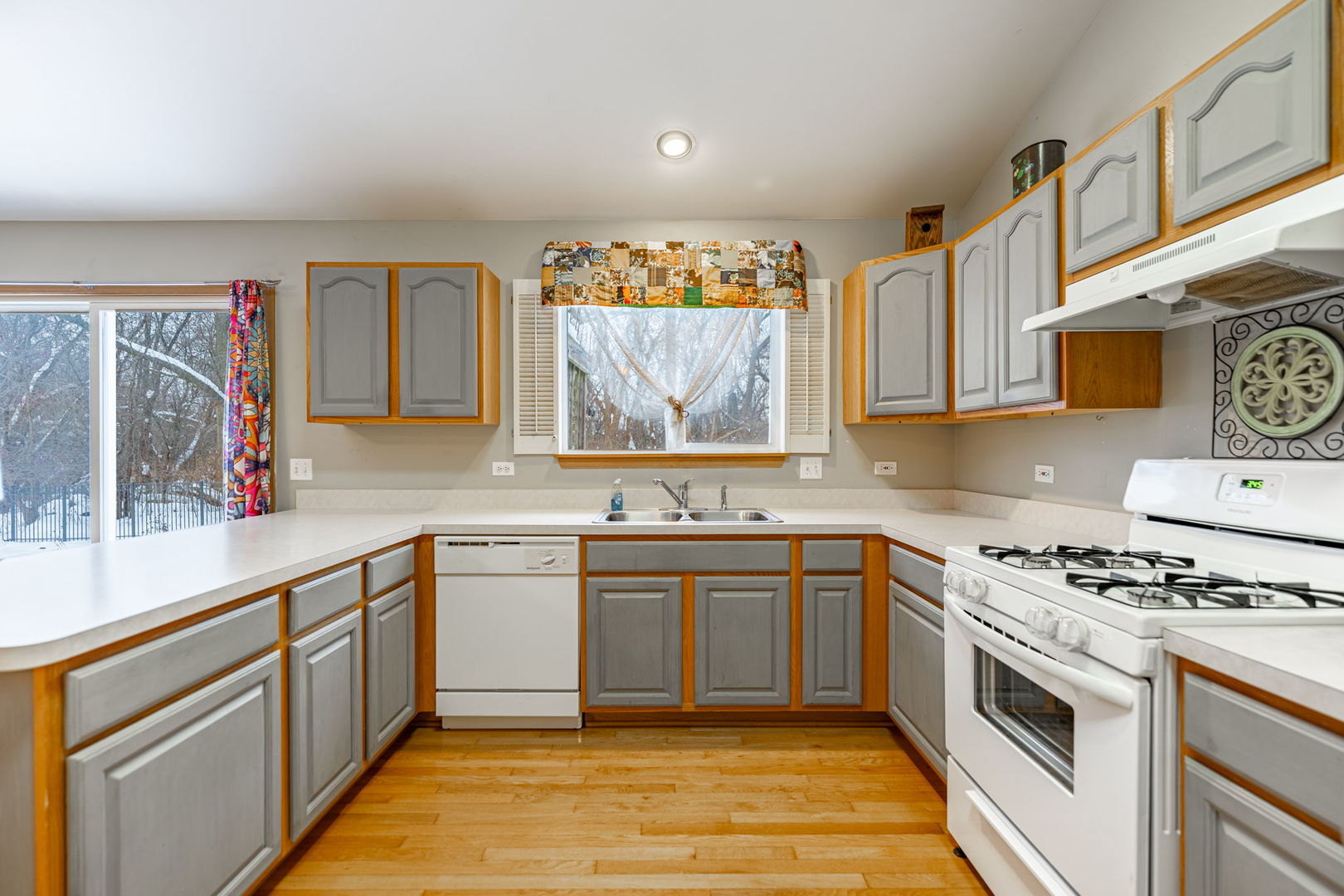 109 Shawnee Lane Harvard, IL 60033 - Photo 7 of 34 a kitchen with stainless steel appliances granite countertop a stove a sink and a microwave