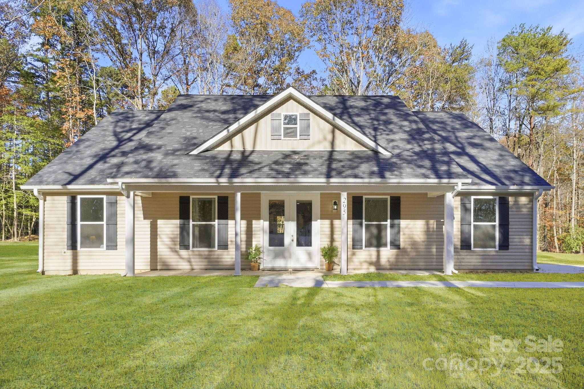 a front view of a house with a yard table and chairs