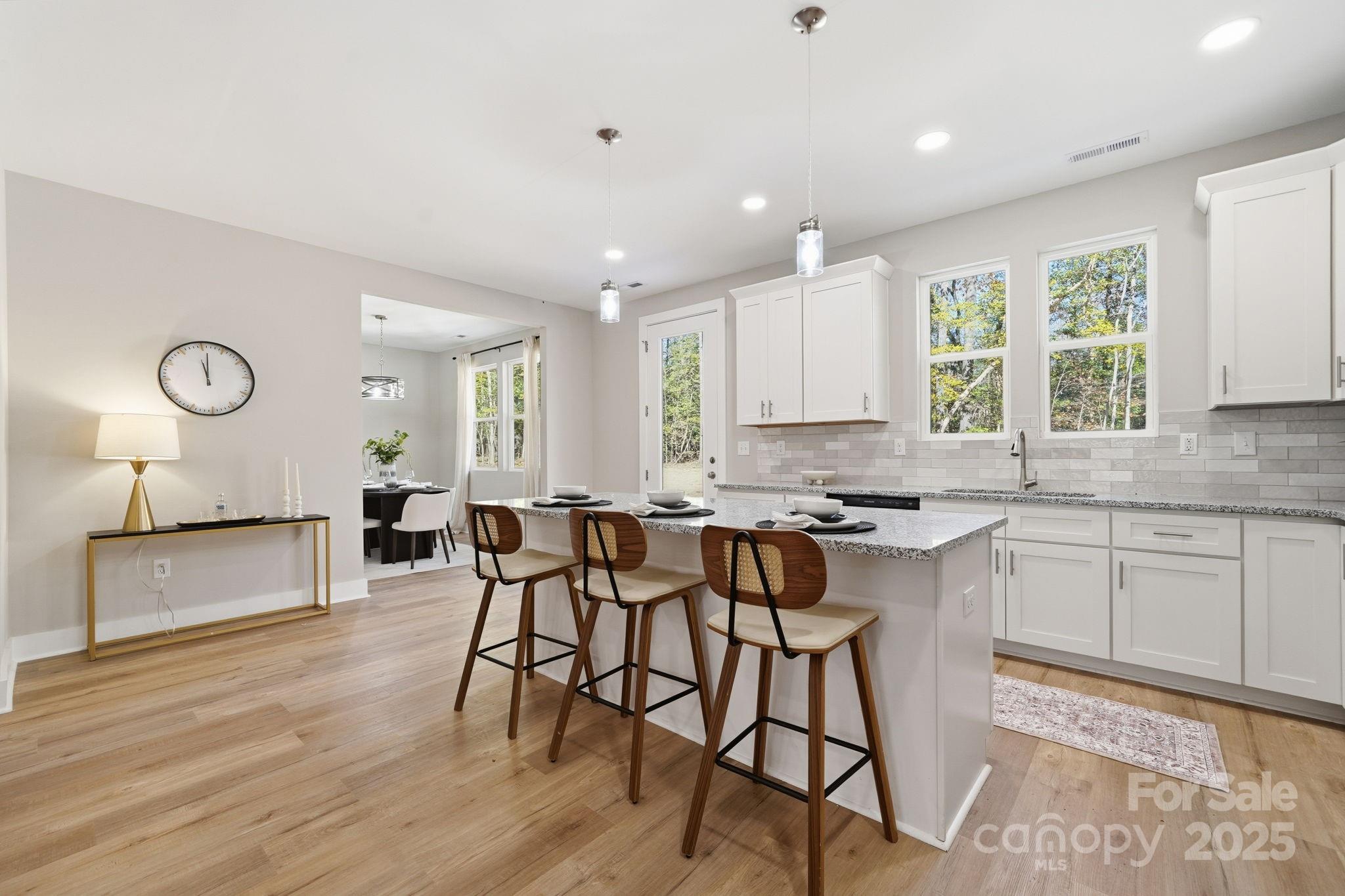 295 Mainsail Road Salisbury, NC 28146 - Photo 13 of 42 a kitchen with stainless steel appliances granite countertop wooden floor window and cabinets