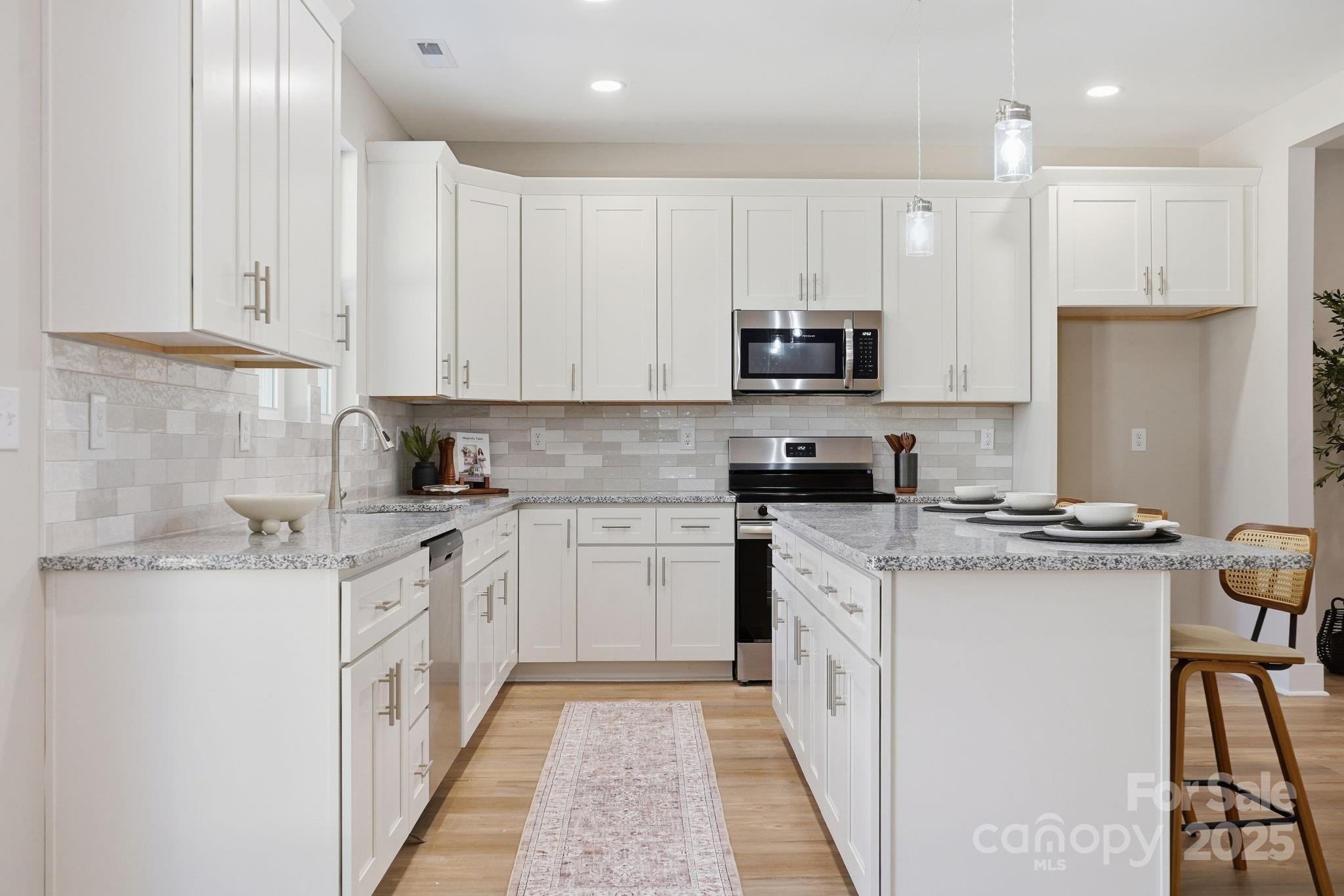 295 Mainsail Road Salisbury, NC 28146 - Photo 20 of 42 a kitchen with stainless steel appliances granite countertop a stove a sink and a refrigerator