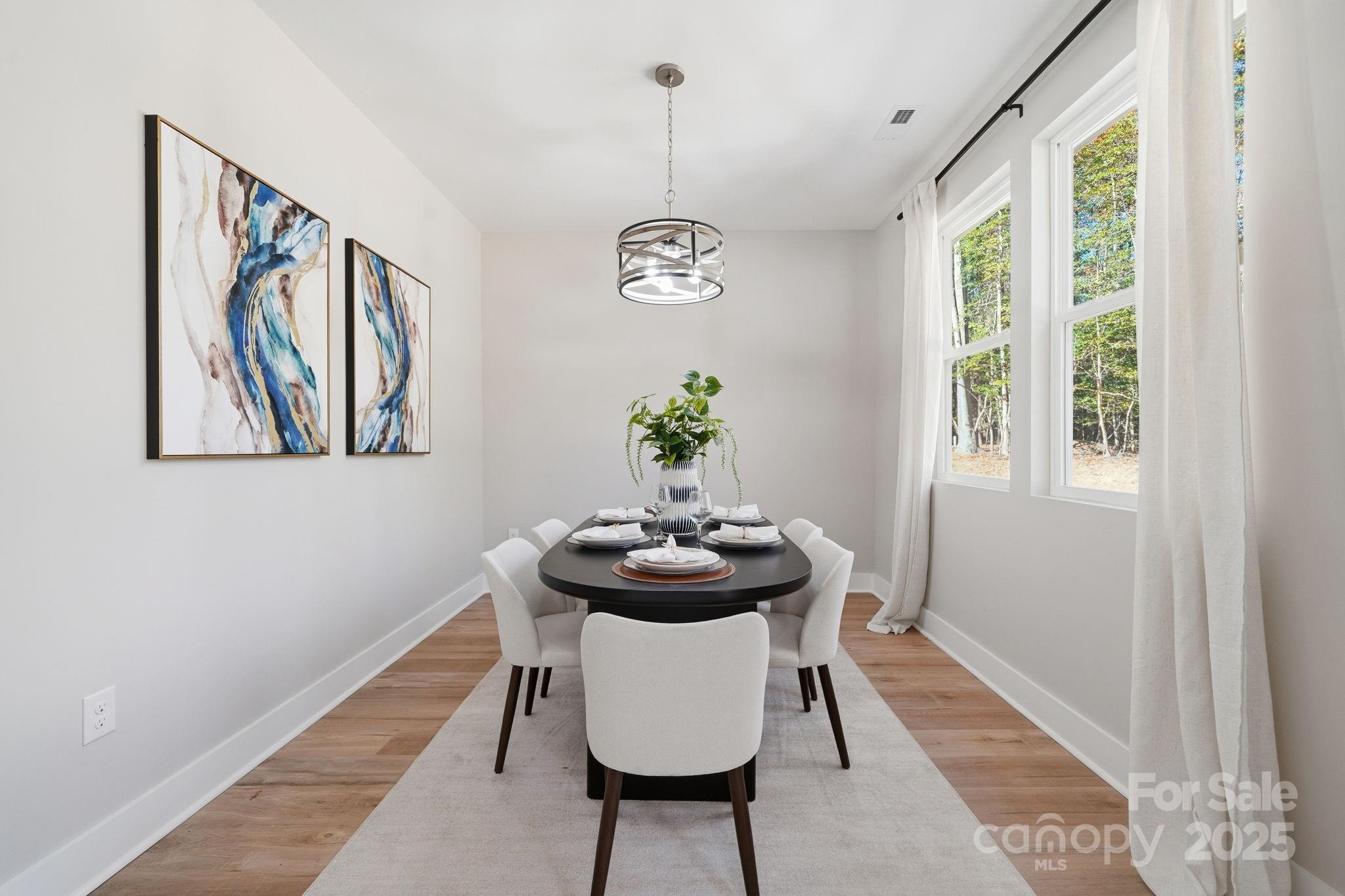 295 Mainsail Road Salisbury, NC 28146 - Photo 21 of 42 a view of a dining room with furniture window and wooden floor