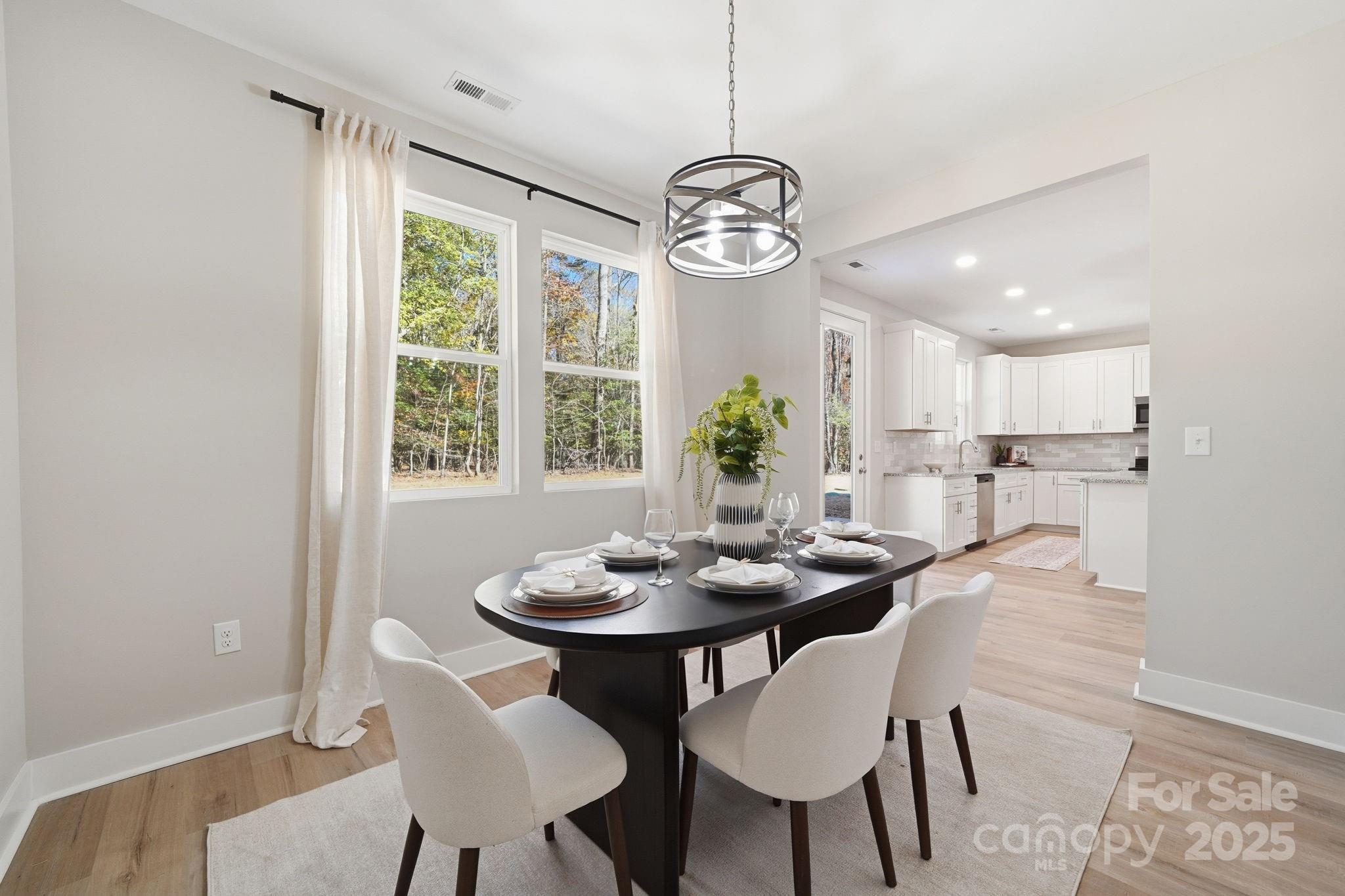 295 Mainsail Road Salisbury, NC 28146 - Photo 22 of 42 a view of a dining room with furniture window and wooden floor