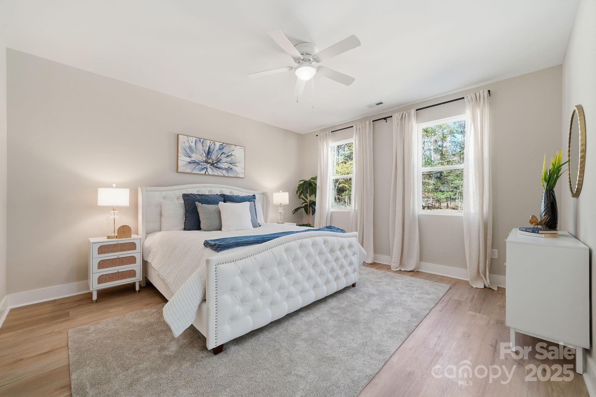 295 Mainsail Road Salisbury, NC 28146 - Photo 23 of 42 a bedroom with a large bed and a chandelier