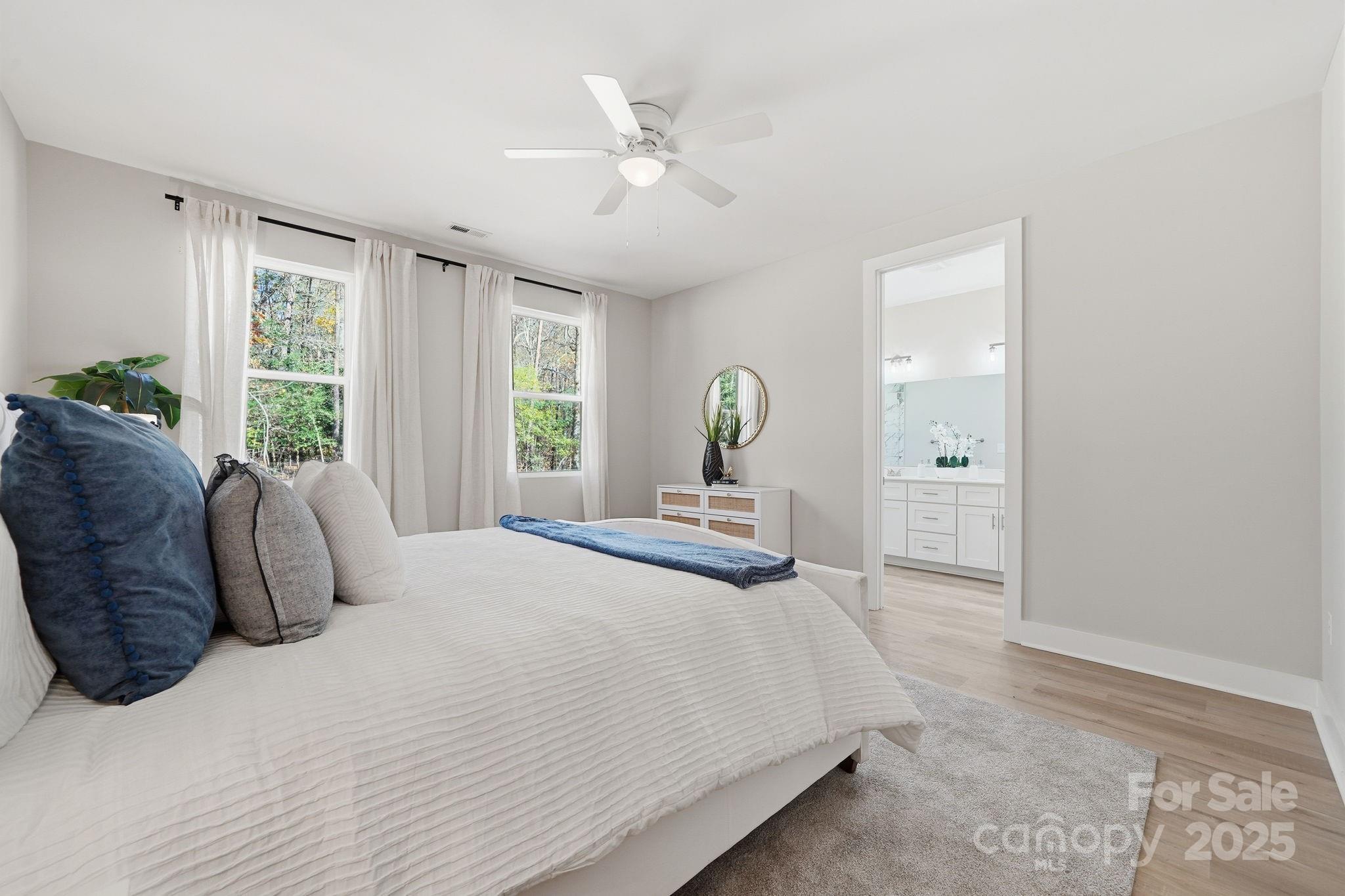295 Mainsail Road Salisbury, NC 28146 - Photo 24 of 42 a bedroom with a large bed and a large window
