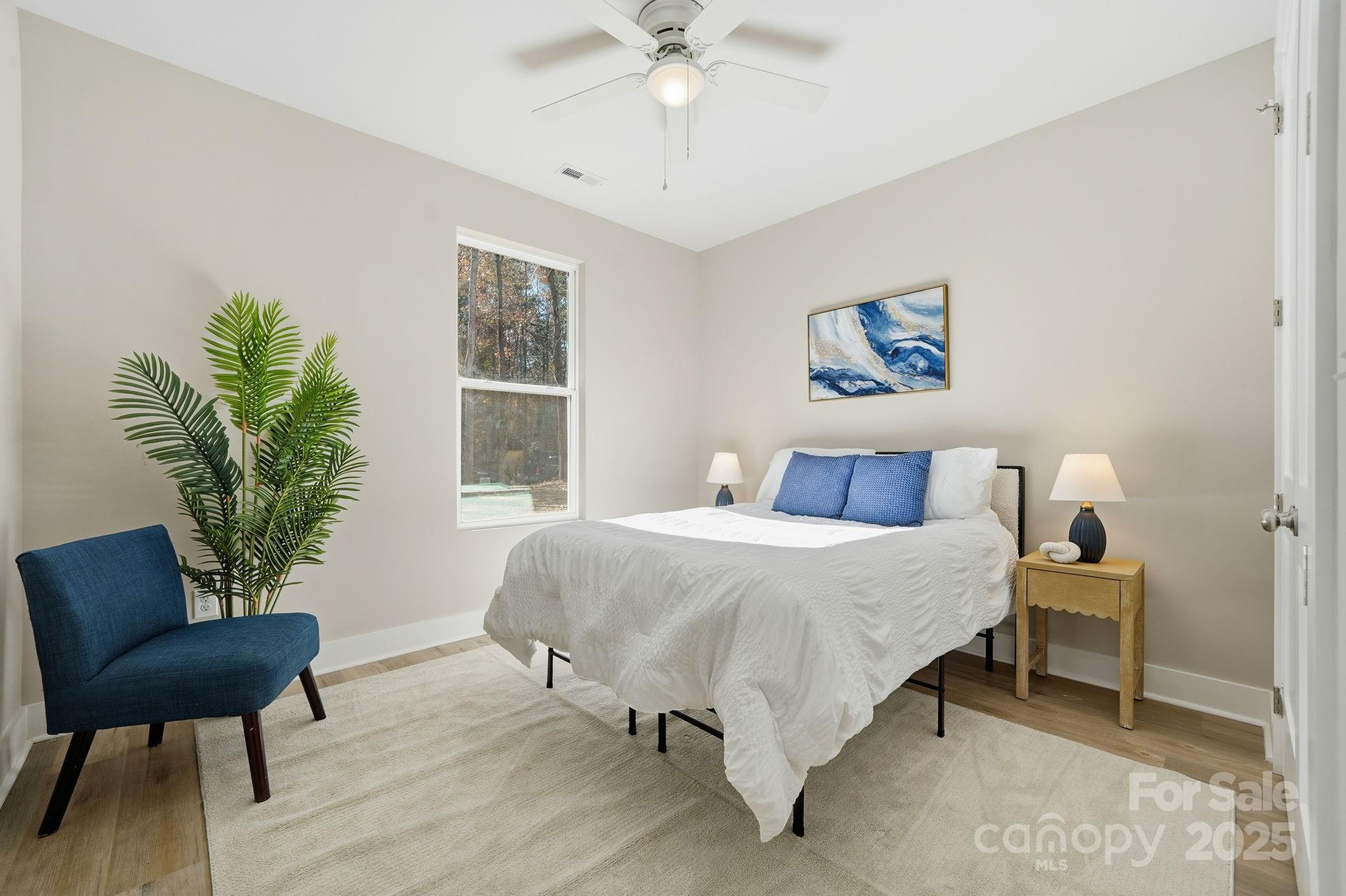 295 Mainsail Road Salisbury, NC 28146 - Photo 28 of 42 a bedroom with a bed and a chair