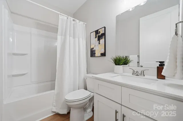 a bedroom with a bed and a potted plant