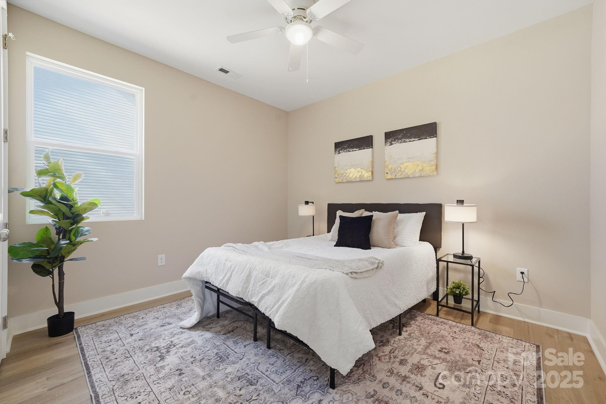 295 Mainsail Road Salisbury, NC 28146 - Photo 30 of 42 a bedroom with a bed and a potted plant