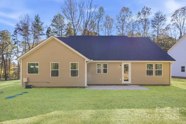 a view of house with backyard