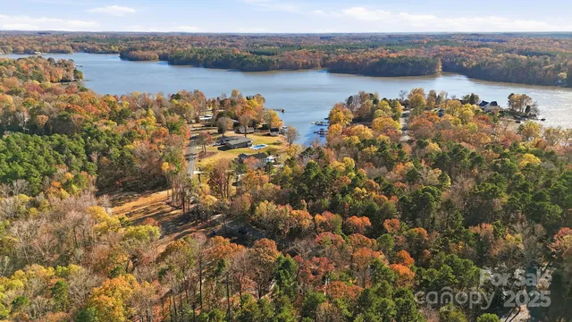 an aerial view of ocean with residential house and outdoor space