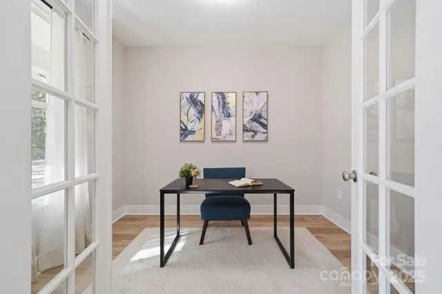 a view of a workspace with furniture and a window