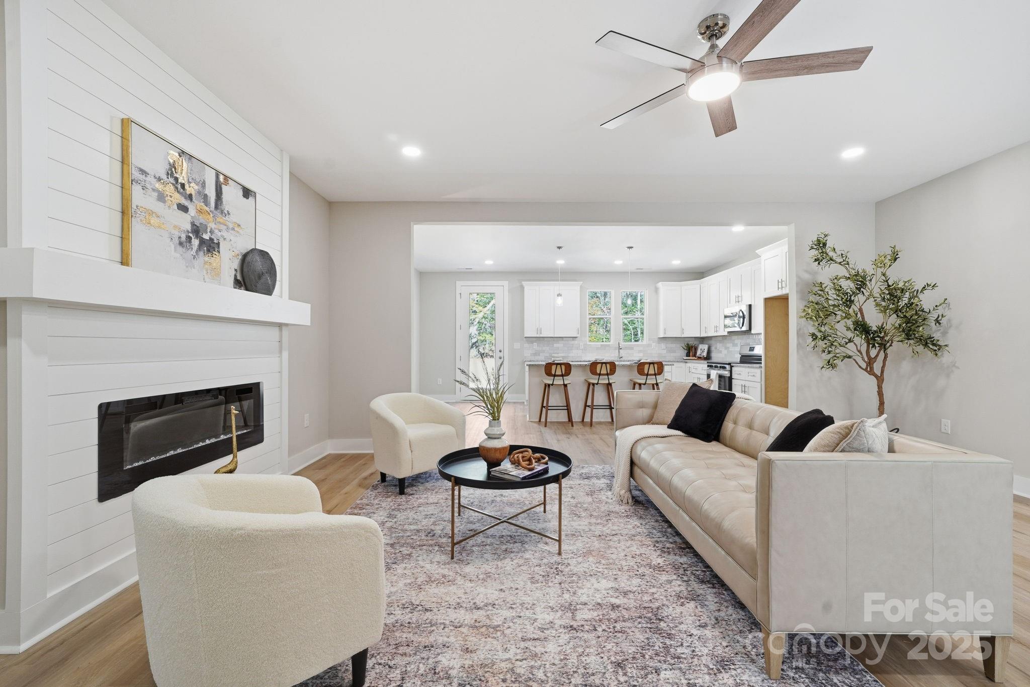 295 Mainsail Road Salisbury, NC 28146 - Photo 10 of 42 a living room with furniture a fireplace and a potted plant