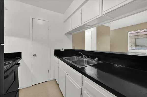 a kitchen with a sink and a refrigerator