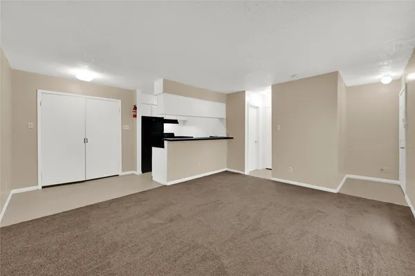 a view of a kitchen with a refrigerator a microwave and a sink