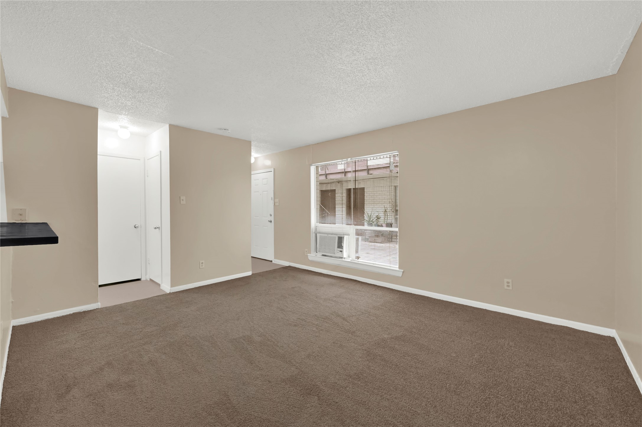 7211 Atwell Drive, Unit 16 Houston, TX 77081 - Photo 5 of 19 an empty room with windows