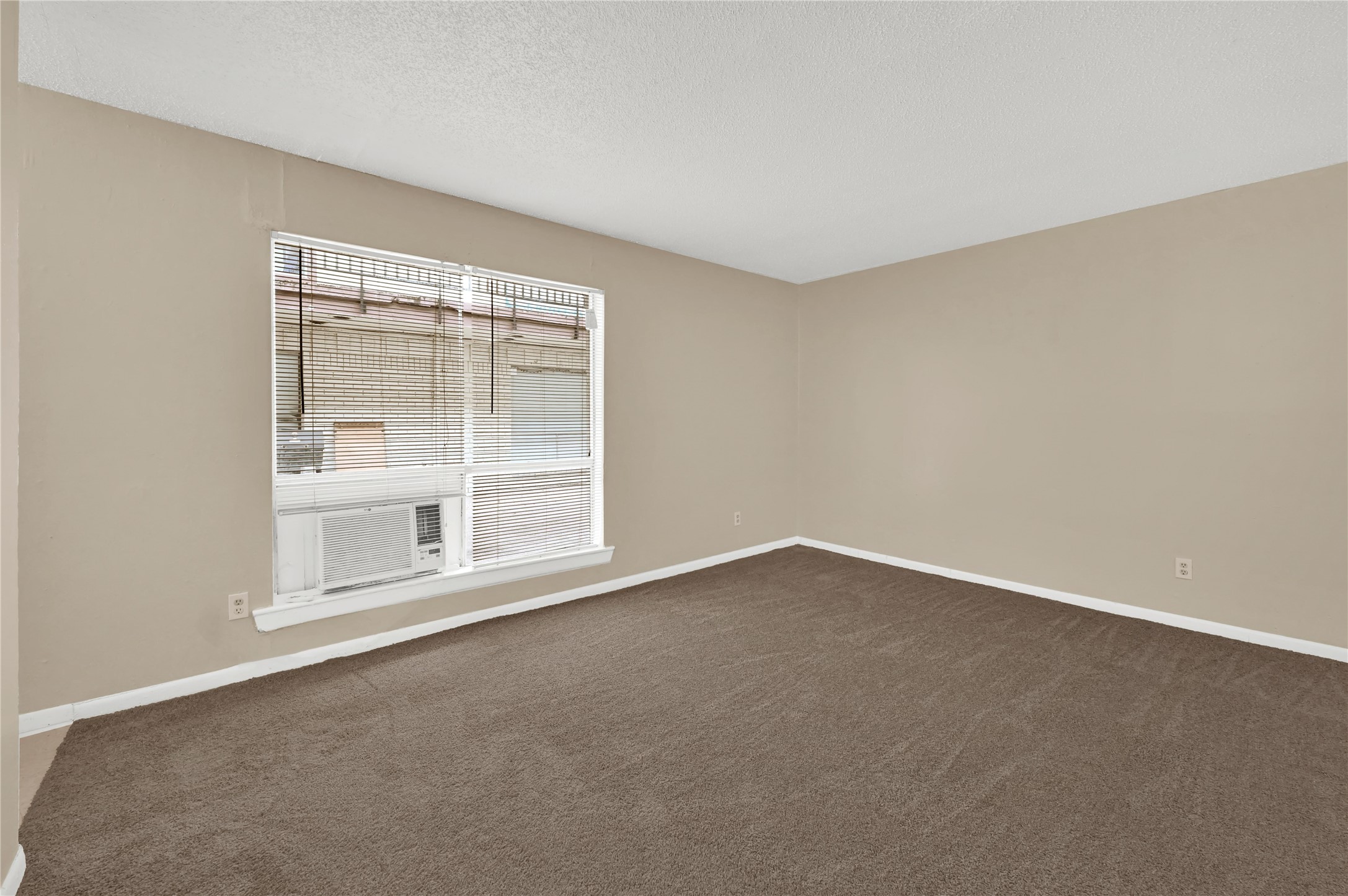 7211 Atwell Drive, Unit 16 Houston, TX 77081 - Photo 6 of 19 an empty room with a empty space and window