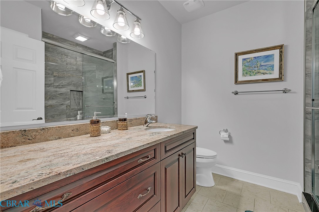 2106 Clarketown Road Heathsville, VA 22473 - Photo 29 of 56 a bathroom with a granite countertop sink a toilet and mirror