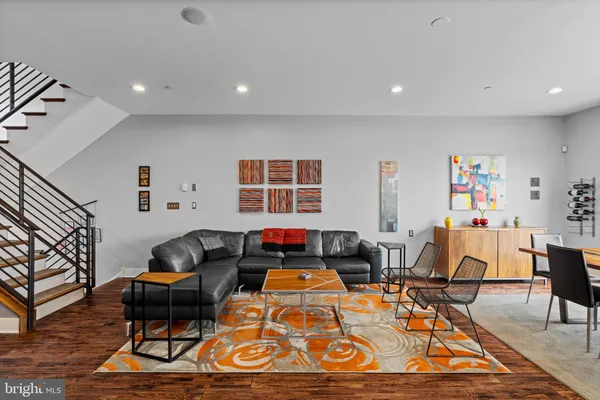 a living room with furniture a rug and a window