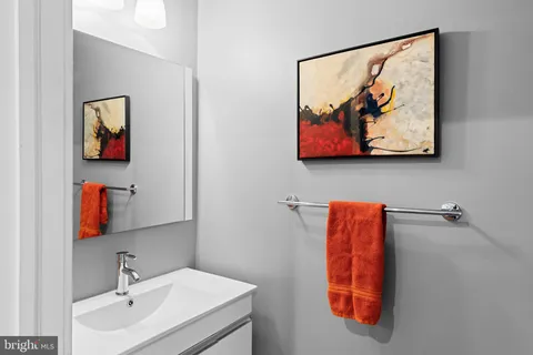a bathroom with double vanity and a shower