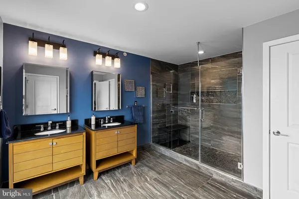a bathroom with double vanity and a shower