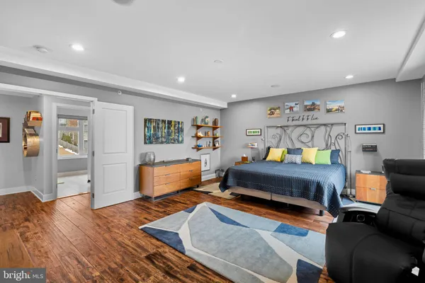 a bedroom with furniture and wooden floor