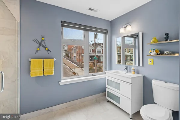 a bathroom with a toilet sink and mirror
