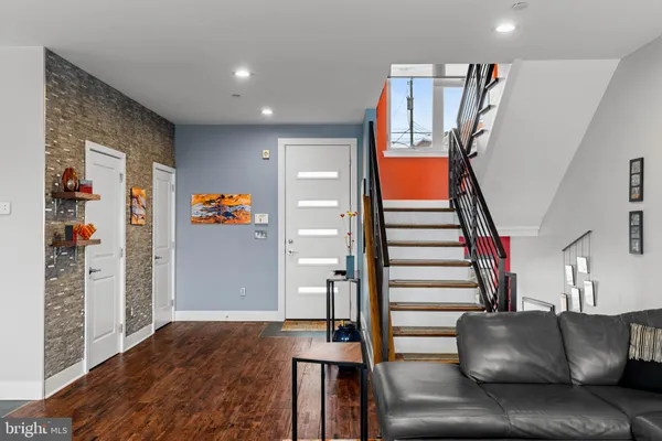 a living room with furniture and stairs