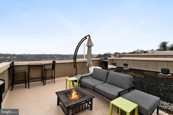 a view of a terrace with chairs and potted plants