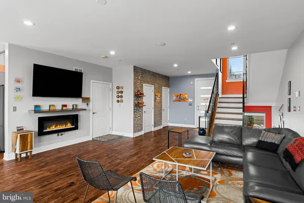 a living room with furniture and a flat screen tv