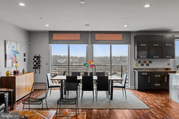 a view of a kitchen with dining table and chairs