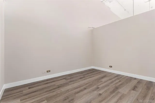 an empty room with wooden floor