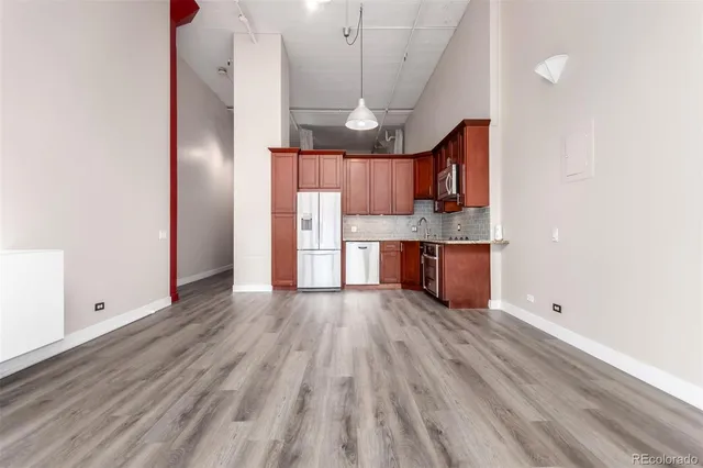 a view of kitchen with wooden floor and electronic appliances