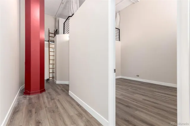 a view of a room with wooden floor