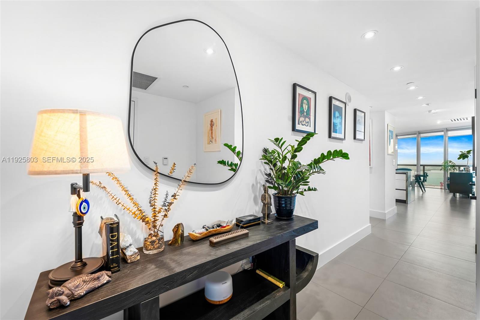 465 Brickell Avenue, Unit 3901 Miami, FL 33131 - Photo 4 of 27 a living room with furniture and a mirror