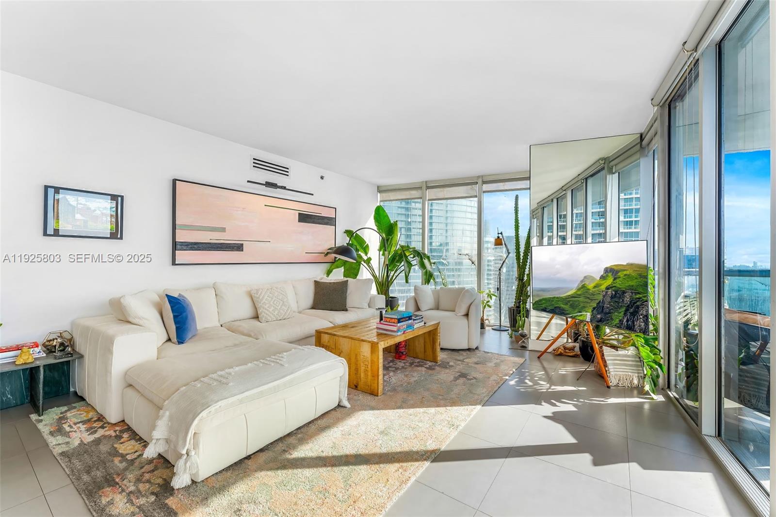 465 Brickell Avenue, Unit 3901 Miami, FL 33131 - Photo 8 of 27 a living room with furniture and a large window