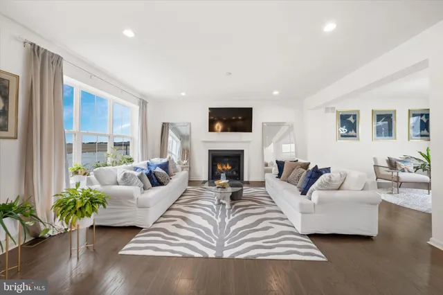 a living room with furniture fireplace and potted plant