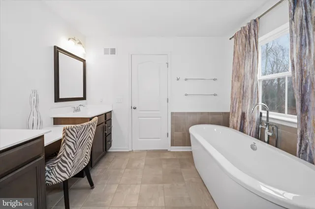 a living room with furniture a table and wooden floor
