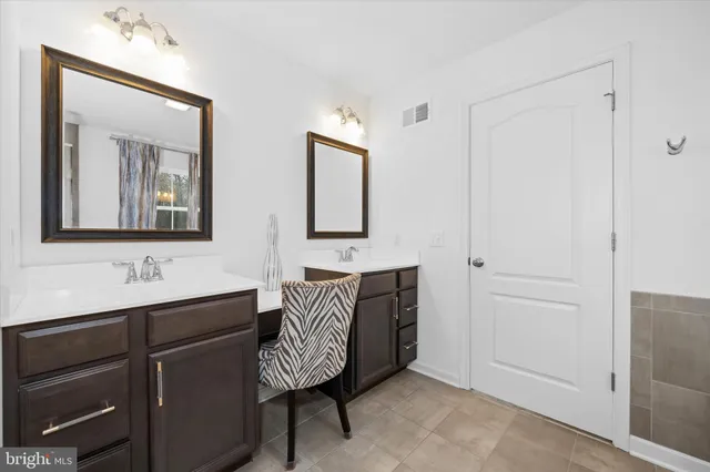 a bedroom with a bed and a large mirror