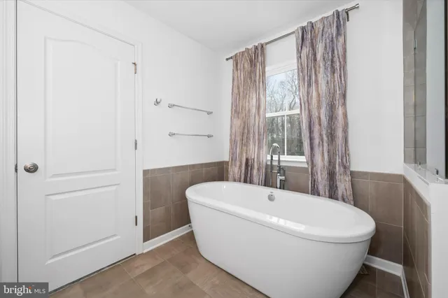 a bathroom with a granite countertop sink a toilet and mirror